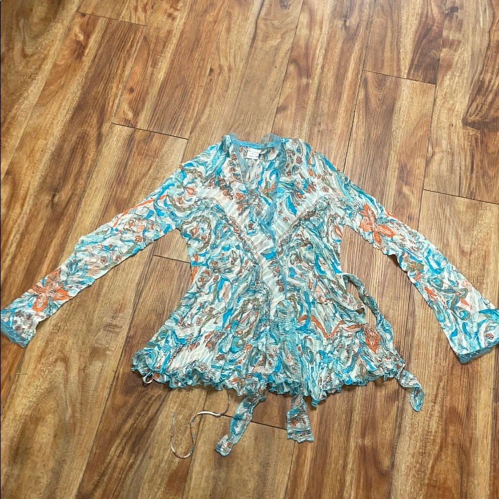 A buttoned blouse with ties in the front